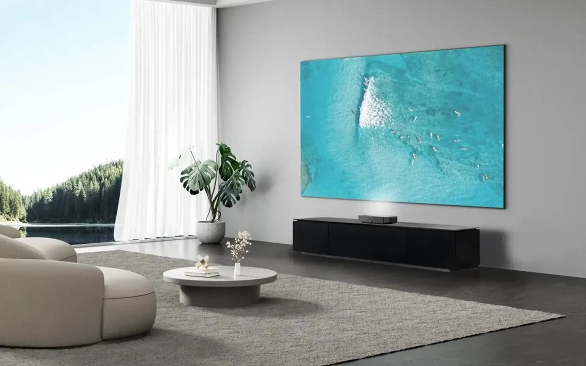 Modern living room with a large flat-screen TV displaying an ocean scene.