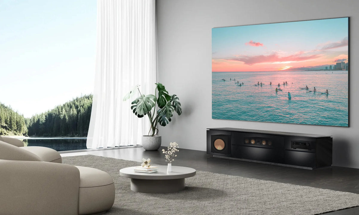 Living room with a large TV displaying a sunset scene, surrounded by decor elements.